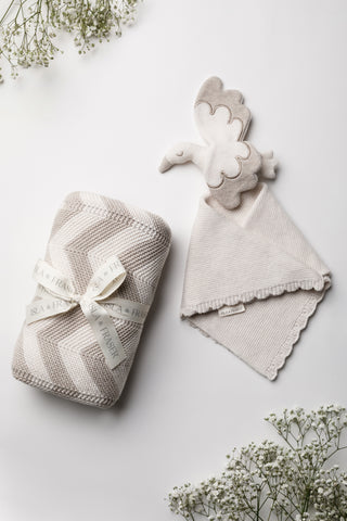 Neutral knitted baby blanket and stork comforter