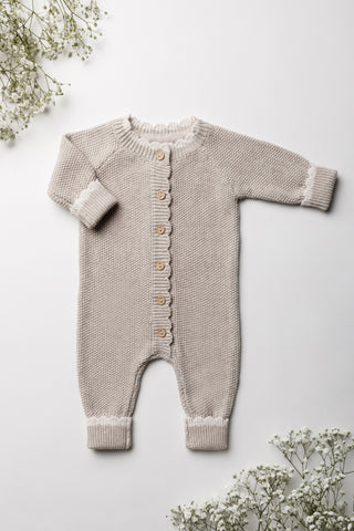 Knitted baby romper in beige 